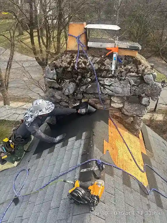 Roofer cutting a raggle groove in stone masonry with angle grinder