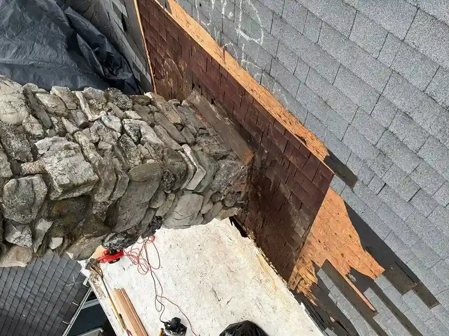 Close-up view of stone chimney metal flashing