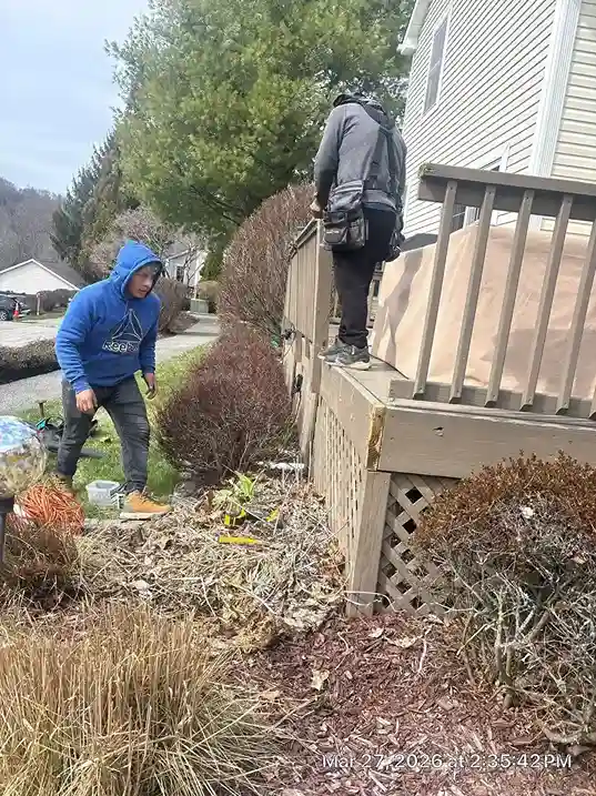 Applying wood stain and protective sealer to cedar deck