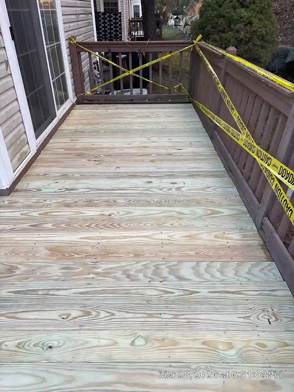 Backyard wooden deck with seating area and steps to lawn