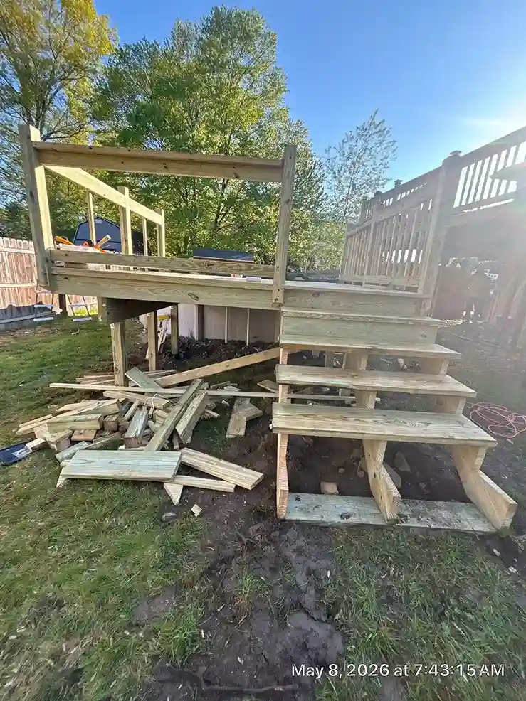 Carpenter measuring and cutting boards for deck staircase railings
