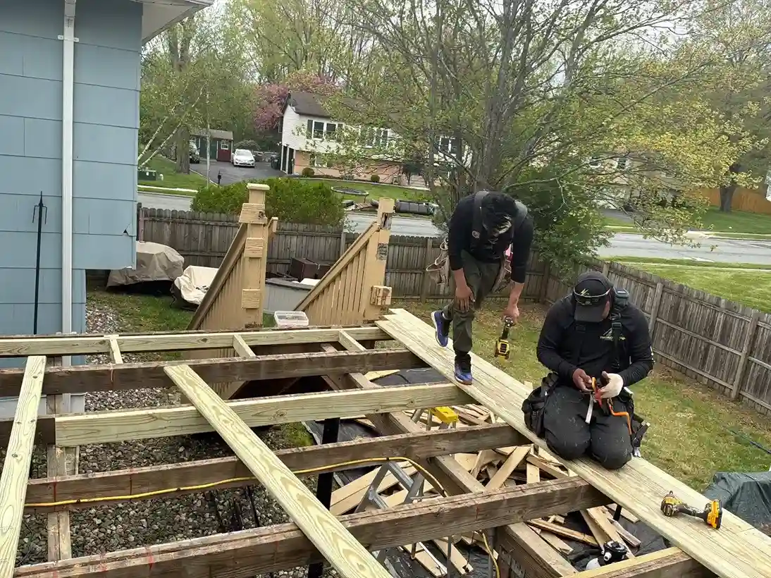 Carpenters framing and building a custom wood deck structure