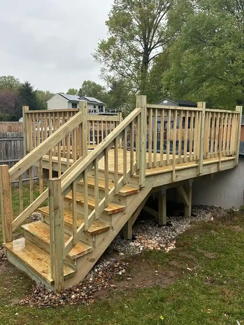 Finished brown pressure-treated wooden deck next to sliding door