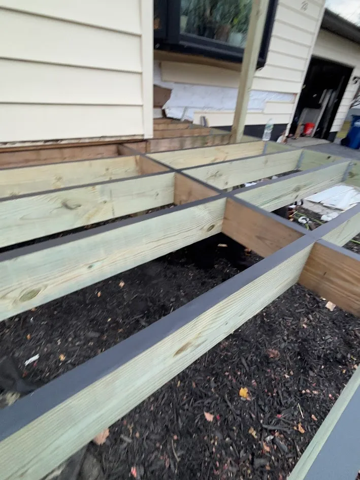 Large custom wooden deck expansion project under construction