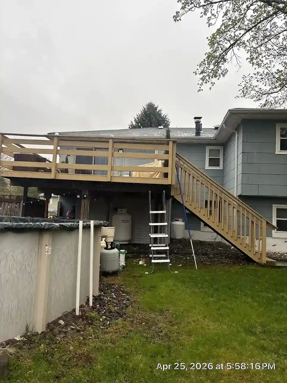 Ledger board attachment and flashing installation against house wall