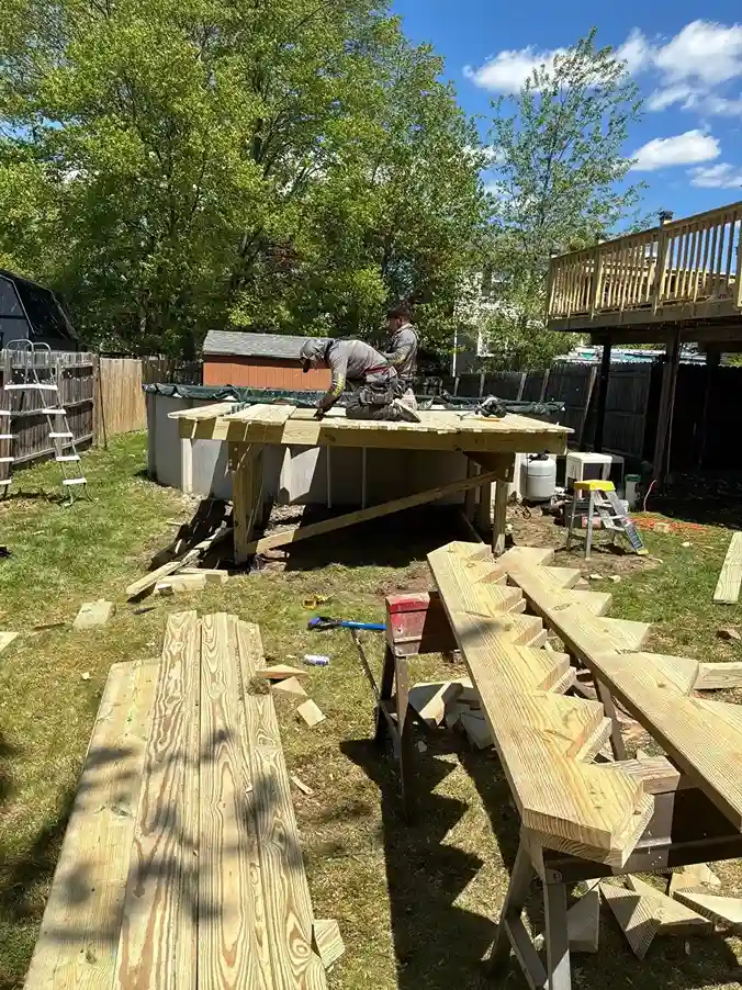 Pouring concrete footings with cardboard Sonotube forms for deck
