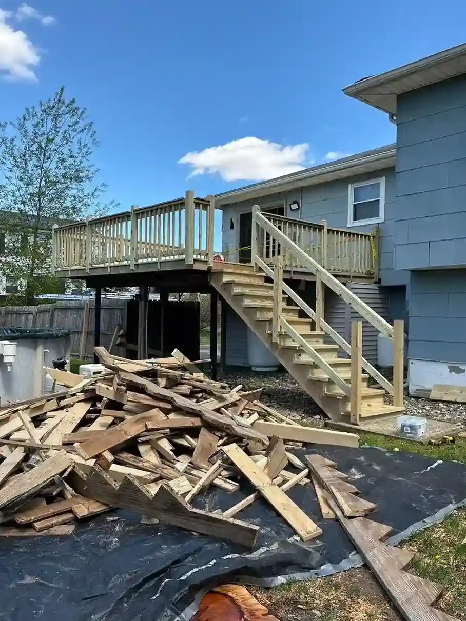 Power washing service restoring weathered grey wood deck boards