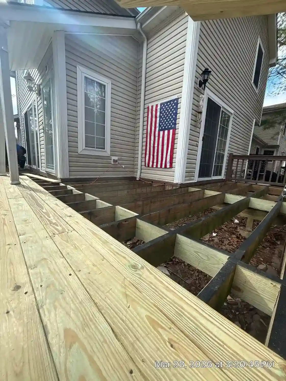 Under-deck drainage and joist construction on elevated deck