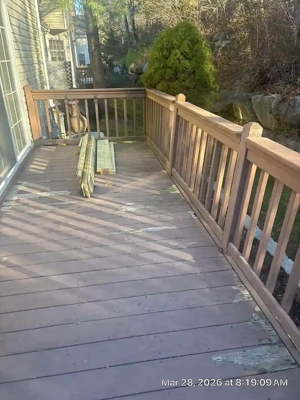 Wooden deck joists under construction with new lumber laid out