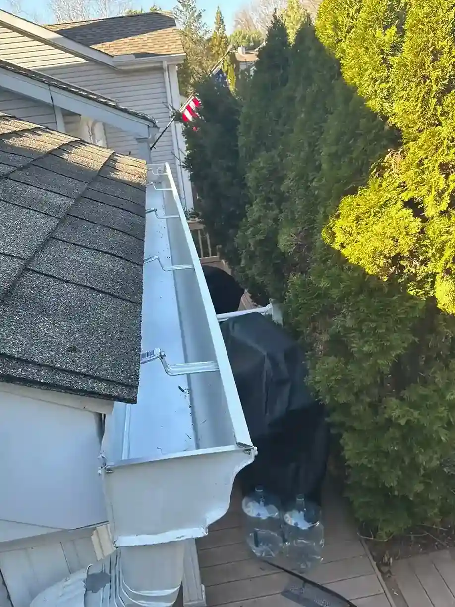 Inside of a newly installed white K-style aluminum gutter