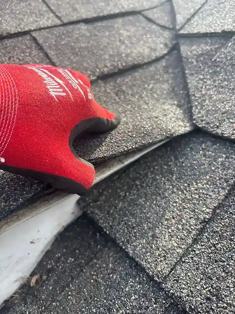 Seamless gutter installation on steep sloped roof architecture