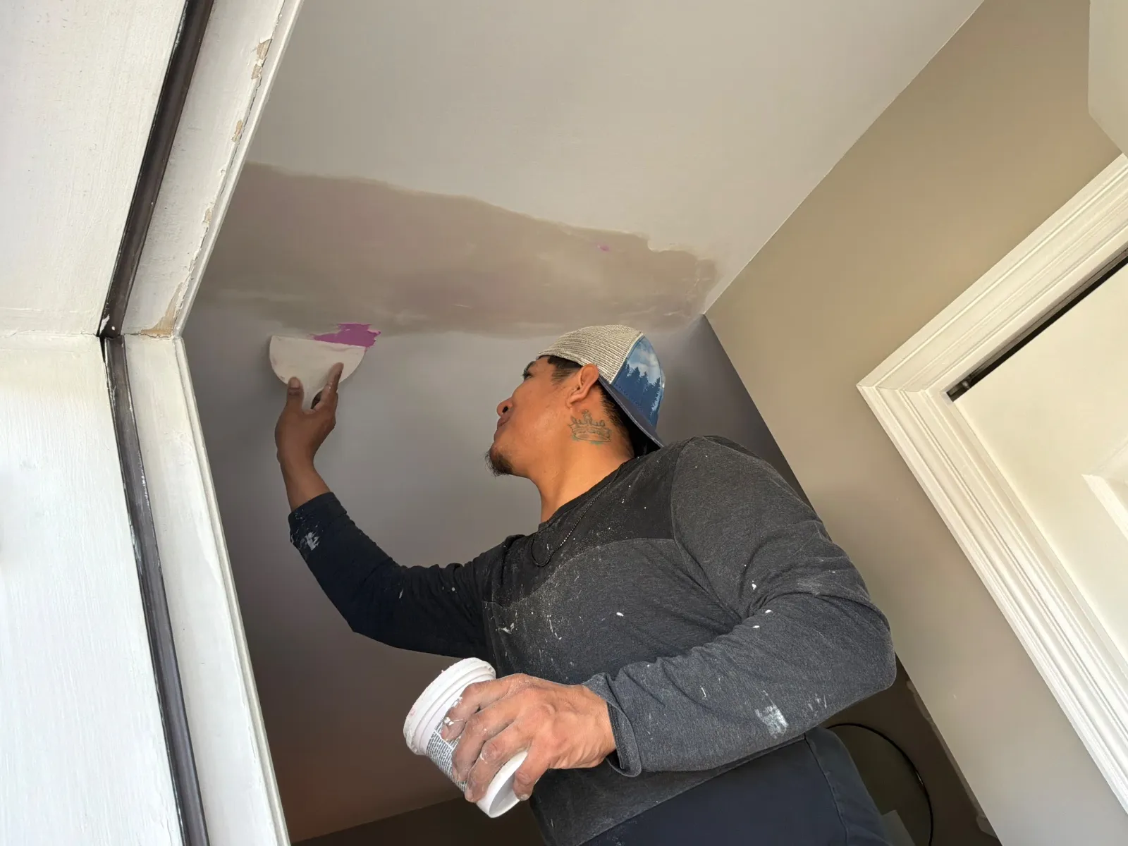 Drywall repair showing application of spackle to wall joints