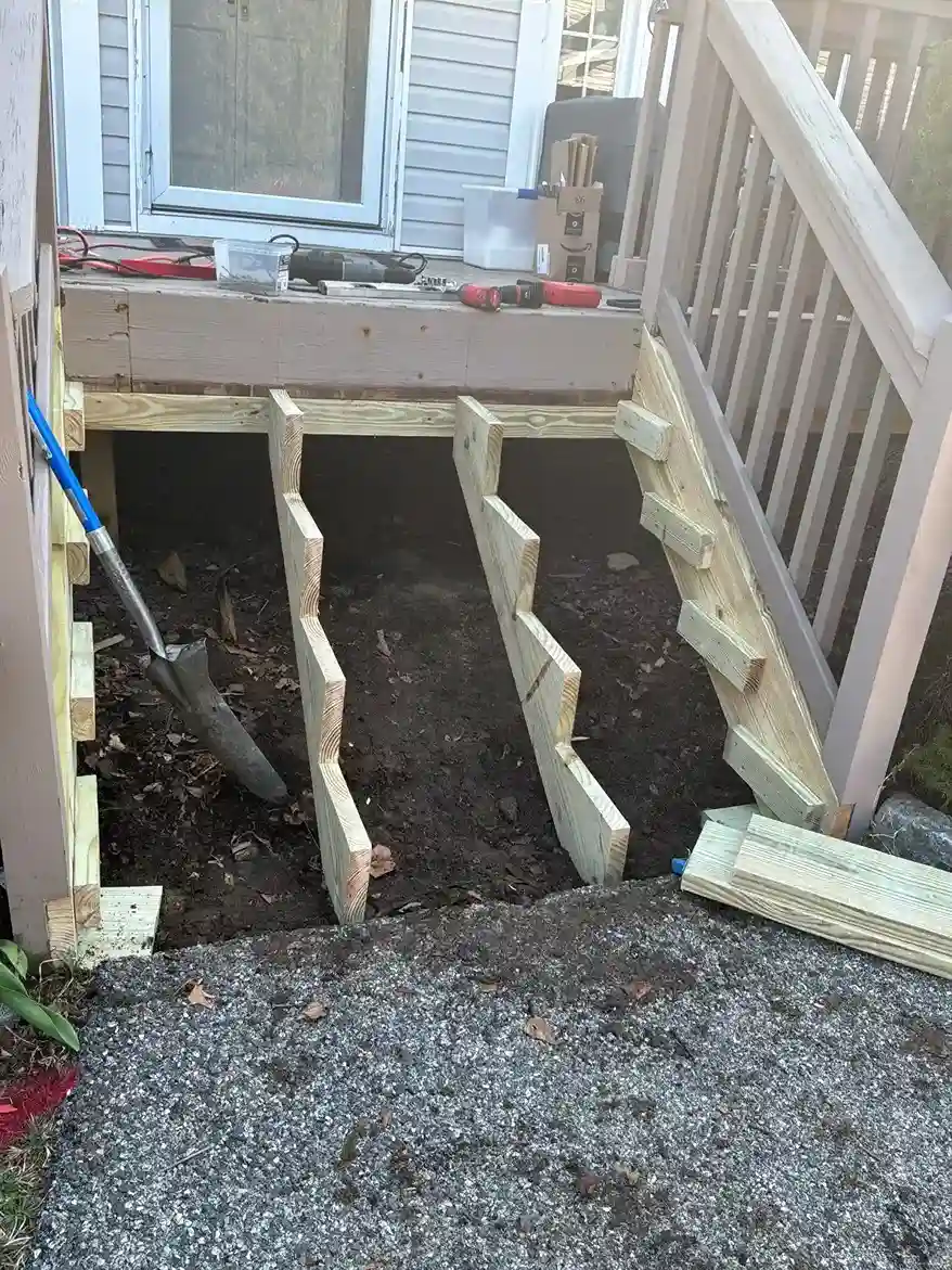 Newly framed wooden stair stringers for backyard deck access