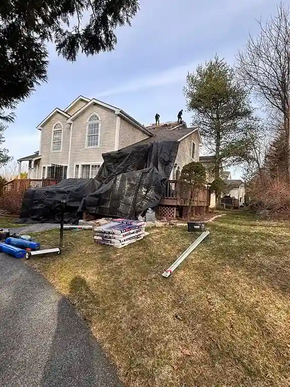 Placing metal flashing in roof valleys to prevent leaks