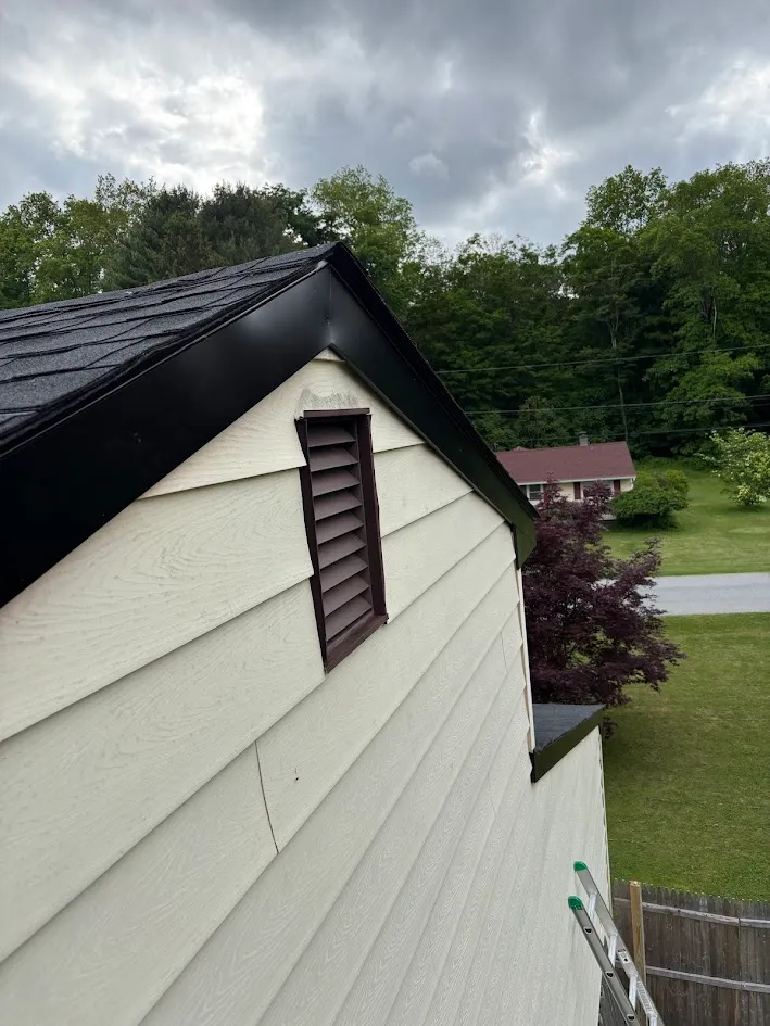 Cream wood horizontal siding with louvered louver vent